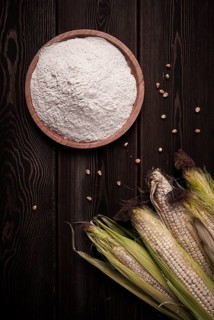 Corn cobs, corn flour, on a wooden table, top view, close-up, rustic, selective focus, dairy corn