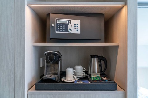 Hotel safe, in a hotel room, coffee machine, glasses, cups, as a service for the guest