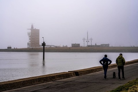 Thick fog in winter, hanging over the mouth of the Elbe into the North Sea, radar tower of the