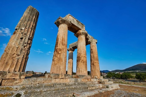 Archaic Temple of Apollo, Doric columns, Sun illuminates ancient stone columns and ruins of a
