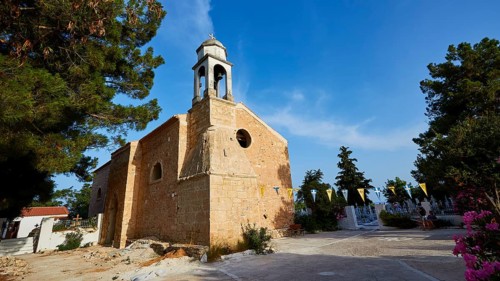 A traditional church with bell tower and blue sky in the background, Koroni, Byzantine fortress,