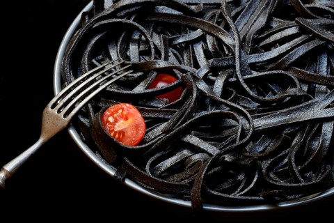 Black pasta coloured with squid ink on a plate, Taglioni al Nero di Seppia, Italy, Europe