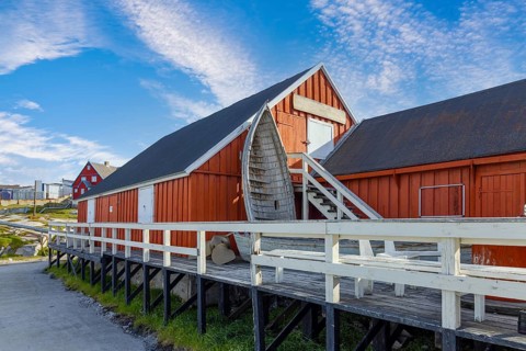 Typical architecture of Greenland Ilulissat with colored houses located near fjords and icebergs