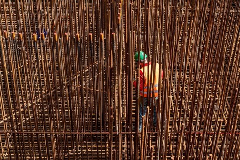 Construction site, reinforced concrete construction site, workers erect a mesh of reinforcing bars,