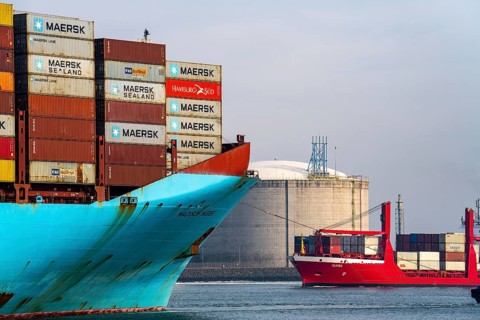 LNG import terminal tanks for liquefied natural gas in the seaport of Rotterdam, harbour tug brings