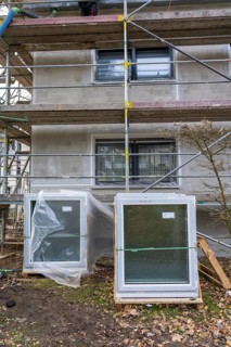 Energy renovation of a residential building, new windows waiting to be installed, on a building