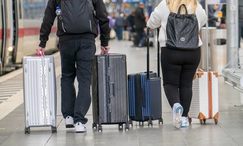 Travellers with luggage, suitcases on a platform, North Rhine-Westphalia, Germany, Europe