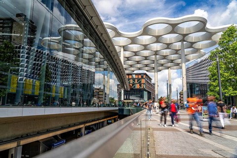 Station forecourt of Utrecht Centraal station, people on their way to, from the station,