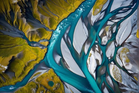 Aerial view perpendicular top down of an abstract colorful river along the coastline, AI generated