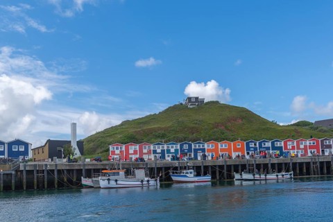 Colourful lobster shacks on the harbour promenade, Börteboote, offshore island Helgoland, blue sky,