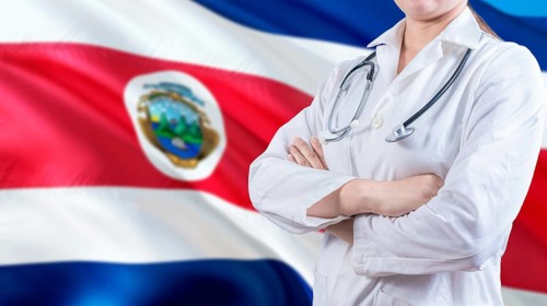 Healthcare concept with Costa Rica flag in background. Female doctor with crossed arms with Costa