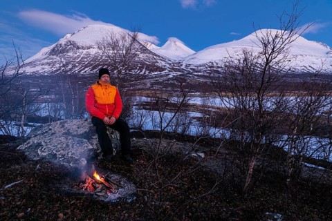 Man at the campfire, Stora Sjöfallet National Park, World Heritage Laponia, Norrbotten, Lapland,