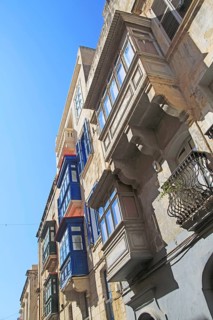 Balconies of houses historic street in city centre of Valletta, Malta, Europe