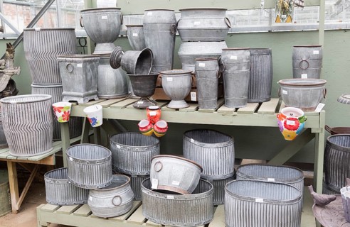 Display of metal planting containers, The Walled garden plant nursery, Benhall, Suffolk, England,