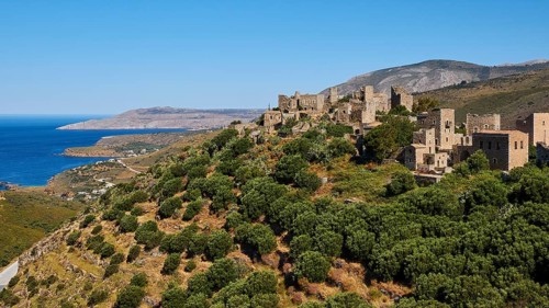 Medieval village overlooking the sea from a wooded hillside, Vathia, residential tower village,