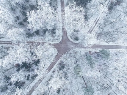 Drone view of snowy forest paths crossing each other, Gechingen, Black Forest, Germany, Europe