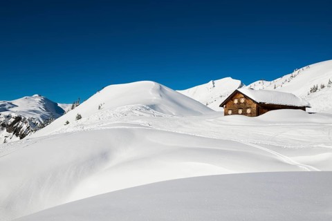 Snow-covered mountains and mountain hut with ski slope, Damüls, Bregenzerwald, Vorarlberg, Austria,