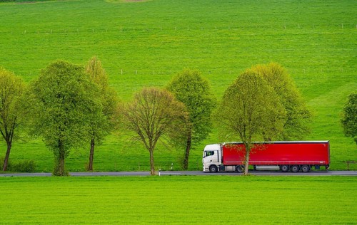 Lorry on a country road, green fields, meadows, trees line the 2-lane road, spring, near Schwelm,