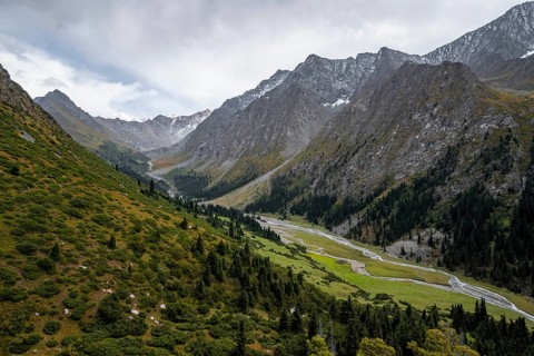 Green mountain valley with river and steep mountain peaks, Chong Kyzyl Suu Valley, Terskey Ala Too,