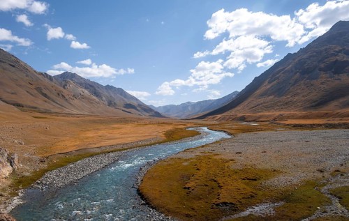Burkhan valley with blue river, mountain landscape with golden meadows, Terskey Ala-Too, Tien Shan,