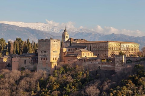 Alhambra on the Sabikah hill, Moorish city castle, Nasrid palaces, behind the snow-covered Sierra