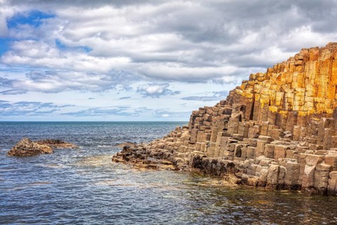 Rocks on the coastline with a view of the sea and cloudy sky, Giant Causeway