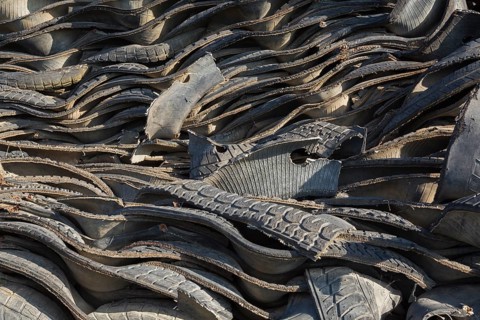 Pile of assorted shredded black rubber motor vehicle tires in recycling yard, Quebec, Canada, North
