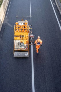 Marking work after the application of new whisper asphalt surface for the A40 motorway, in the