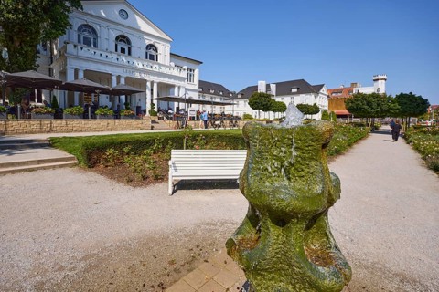 Park, rose garden with fountain, bench and Leopold Bad restaurant in Bad Salzuflen, Lippe district,