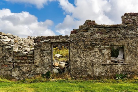 Facade of a ruin, dilapidated stone house, overgrown, symbolic photo Great Famine, Achill Island,