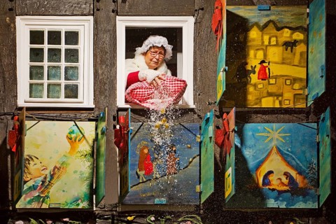 Mrs Holle shakes out her pillow of gold coins at the large Advent calendar at the Old Town Hall,