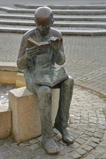 Sculpture Book reader at the fountain in front of the town library, reader, literature, books,