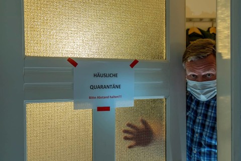 Symbolic image Domestic quarantine, man is in isolation at home due to a suspected corona
