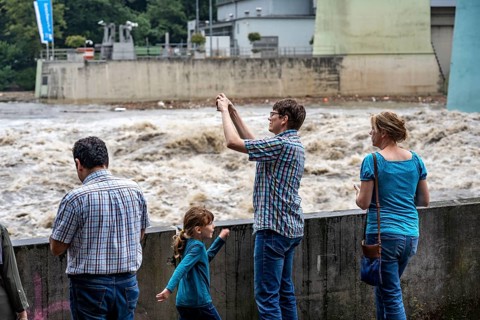 Weir of the Lake Baldeney in Essen, the masses of water roar through the open weirs, spectators,