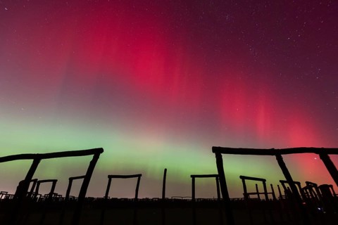 Northern lights (aurora borealis) over the ring sanctuary of Pömmelte, prehistoric circular ditch