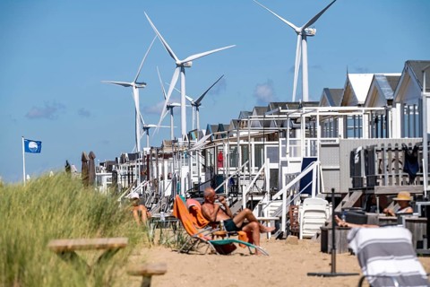Wind turbines, wind farm, holiday homes, beach houses on the beach of Ijmuiden in North Holland,