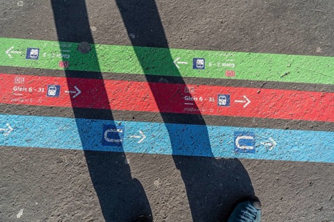 Signpost on the pavement, for bus and train diversions at Dortmund Central Station, during