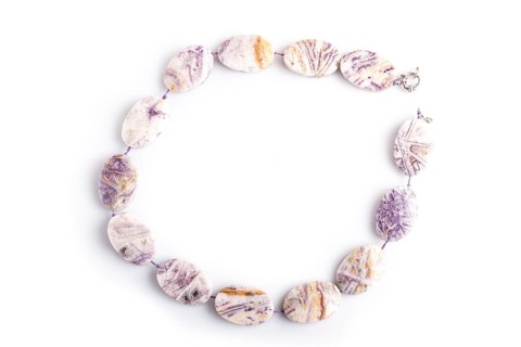 Agate colored beads isolated on white background. top view, close up