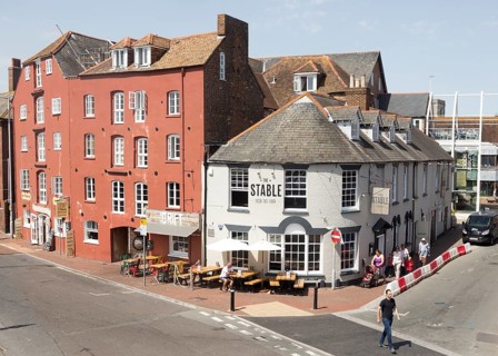 Old historic buildings on quayside at Poole harbour, Poole, Dorset, England, UK