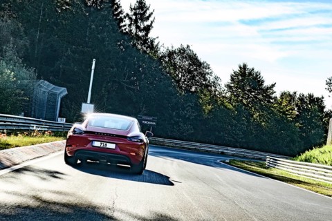 View from perspective of racing driver on sports car Porsche Cayman driving on Nürburgring race