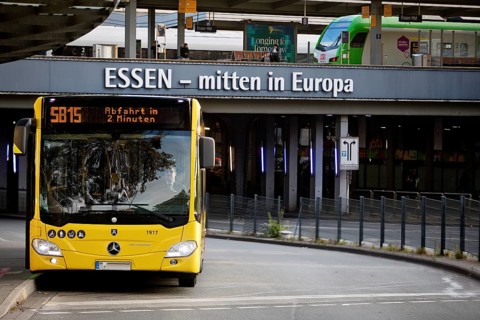 Essener Verkehrsbetriebe bus at the main railway station with local train, public transport,