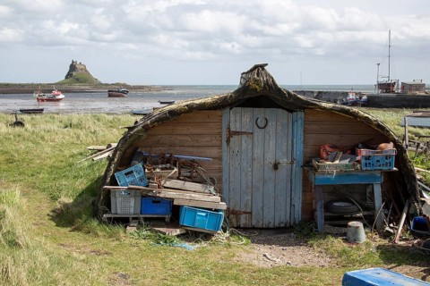 Upturned boats used as storage shed, Holy Island, Lindisfarne, Northumberland, England, UK