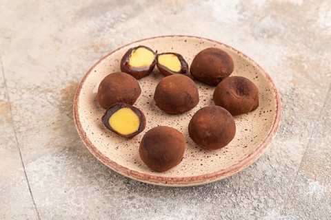 Japanese rice sweet buns chocolate mochi filled with cream on brown concrete background. side view
