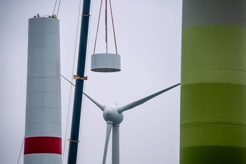 Construction of the tower of a wind power plant in a wind farm near Issum, 9 older wind turbines