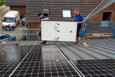 Installation of solar modules on the roof of a barn on a farm, over 240 photovoltaic modules are