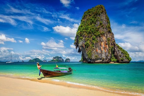 Thailand tropical vacation concept background, Long tail boat on tropical beach with limestone