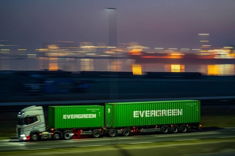 Lorry on the road to Euromax Terminal Rotterdam, ENECO wind farm on the dike around the port of
