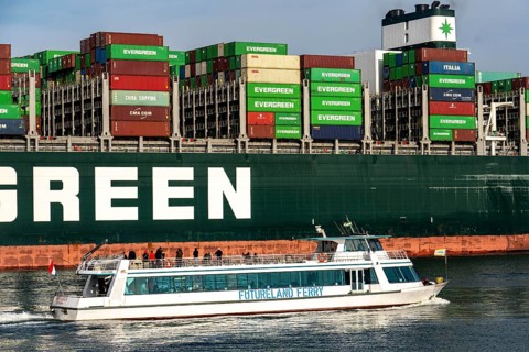 Harbour tugs bring the container freighter Ever Globe to its berth at the Hutchison Ports ECT