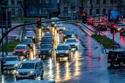 Rainy weather, road traffic, intersection, lights of vehicles on a wet road, traffic lights, tail