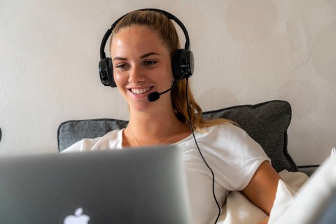 Young student learns at home, online, in conversation with other students